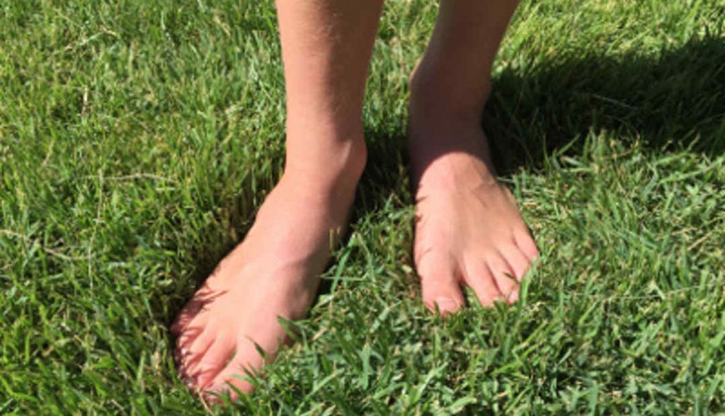 feet on green grass