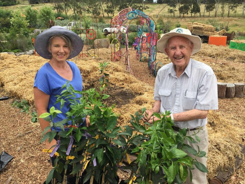 man and woman in citrus grove